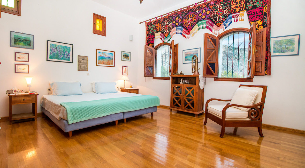 Double Bedroom with wooden flooring and stunning views property for sale in Rhodes, Greece