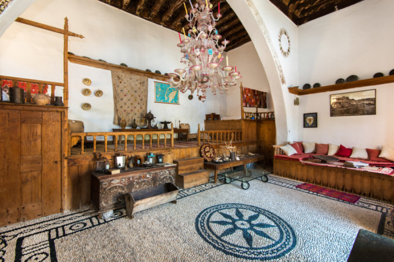 Lindian traditional pebble flooring and high wooden beds, property for sale in Rhodes, Greece