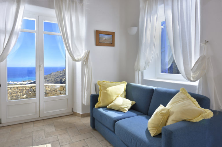 Bedroom with sitting area and sea views villa for sale in Mykonos Greece