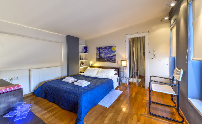 Bedrooms have warm wood floors villa for sale in Crete Greece