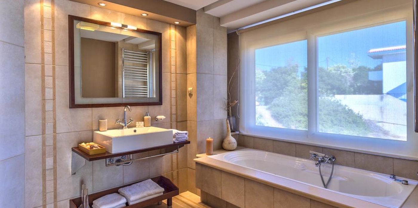 A full bathroom with tub villa for sale in Crete Greece