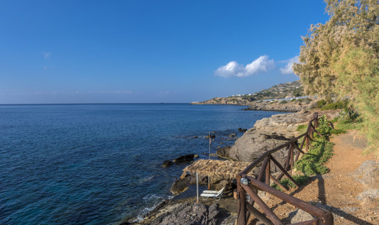 A quaint pathway carved out of the rocks down to the sea villa for sale in crete Greece
