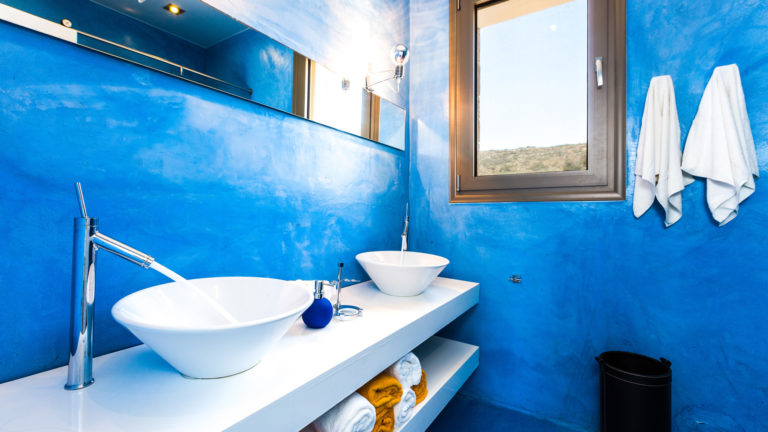 One of the bathrooms in blue villa for sale in Crete Greece