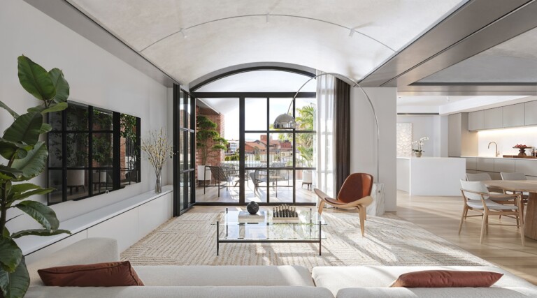 Living room at FIX Residences with an arched window framing views over Thessaloniki