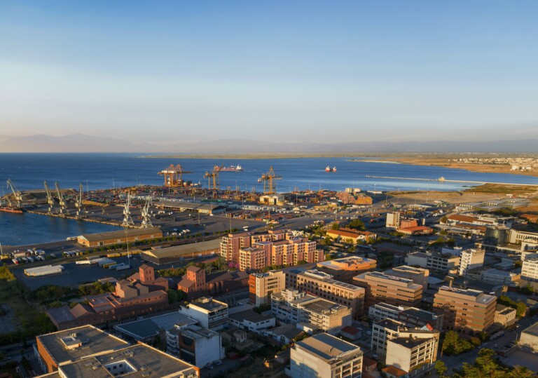 Aerial view of the FIX Thessaloniki site at the city's western gateway, with the port and the Thermaic Gulf beyond